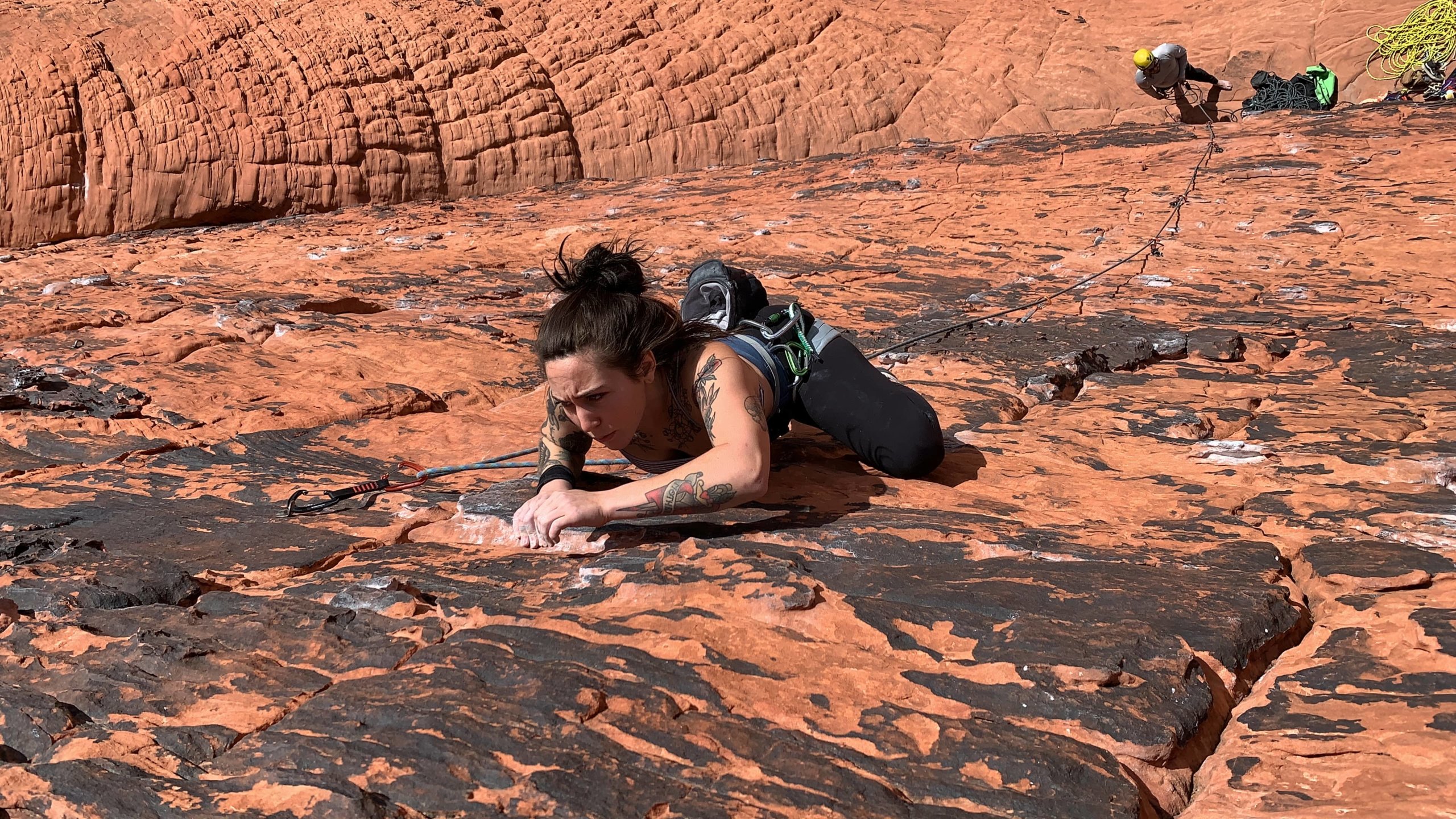 Ally Malone bouldering in Girlfriend Collective dress