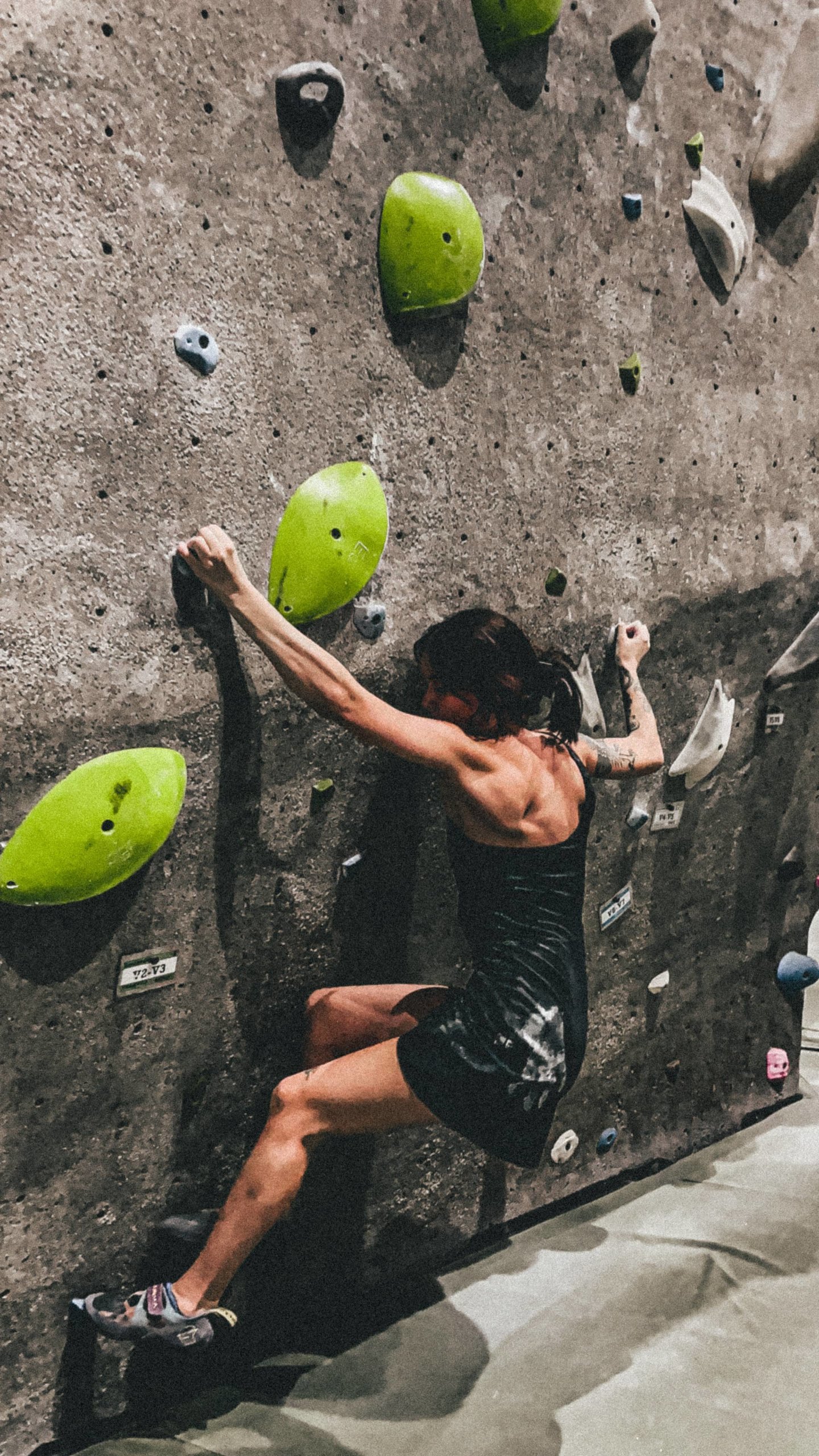 Ally Malone bouldering in Girlfriend Collective dress