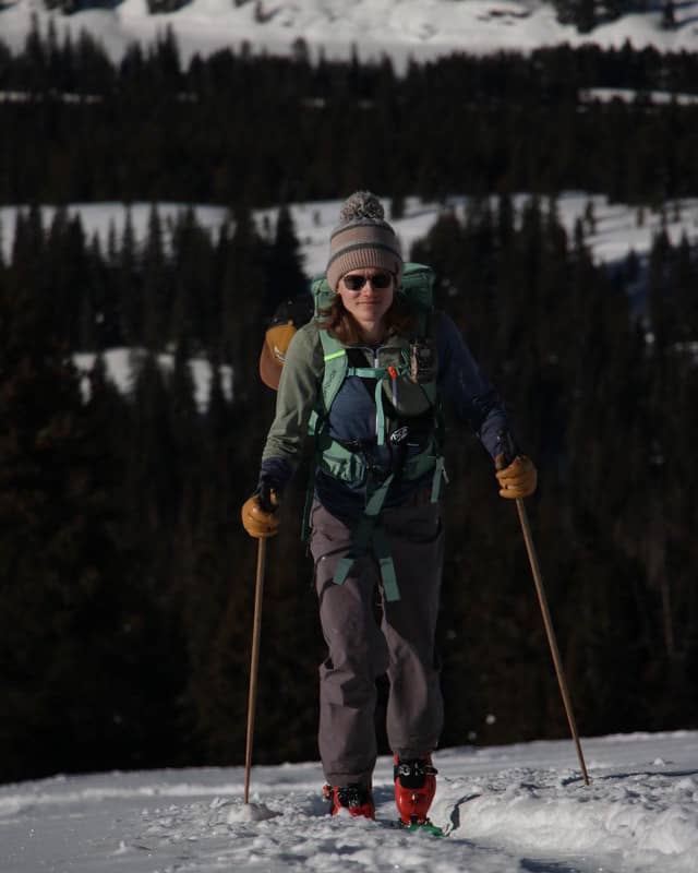 Valerie Arcara hiking up the mountain on her skis