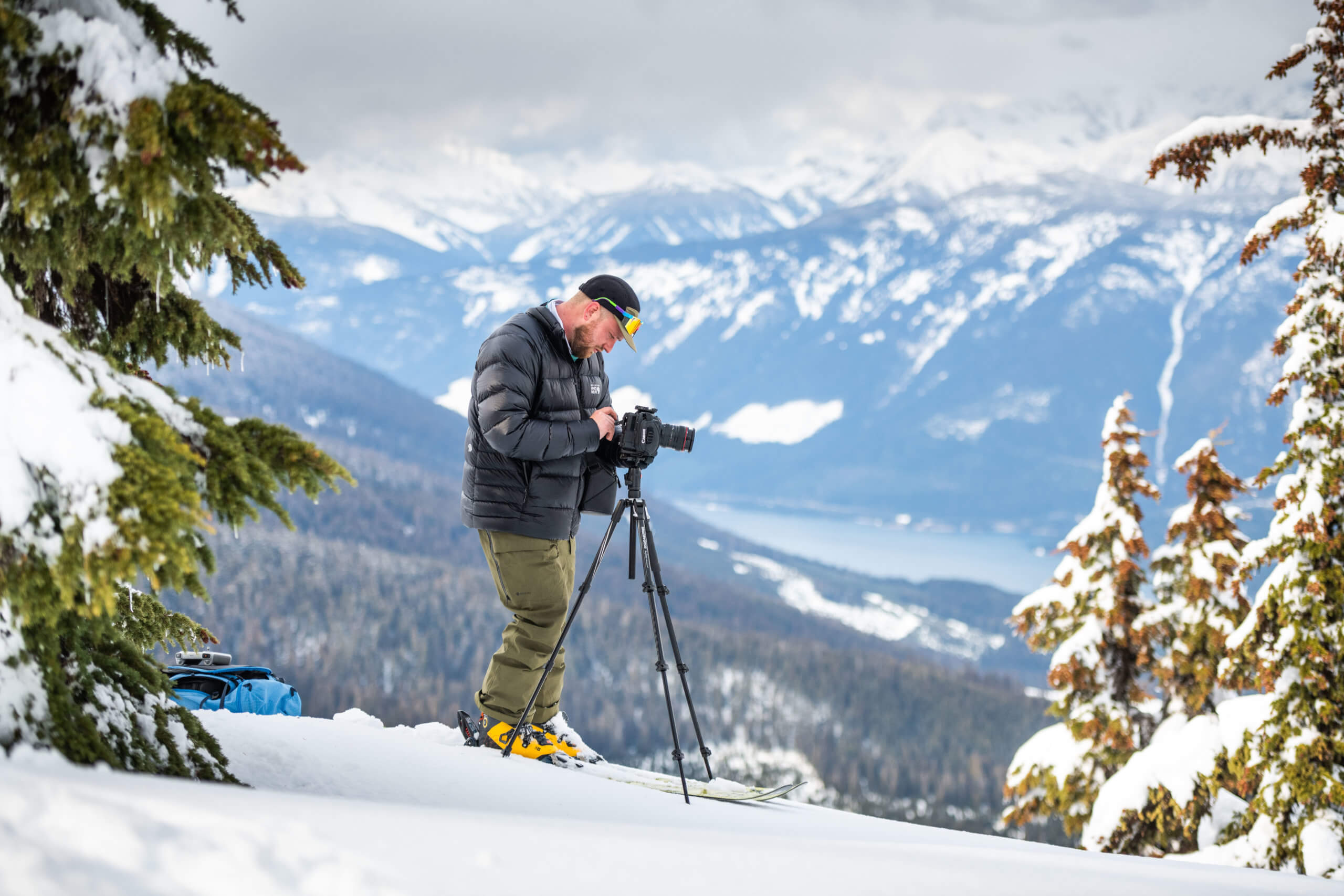 Ryan Collins at top of mountain with camera.