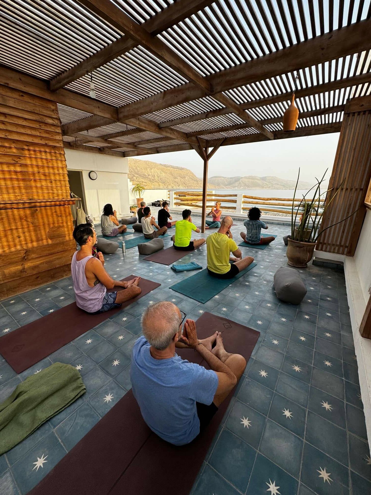 Rainbow Surf Retreat doing yoga together.